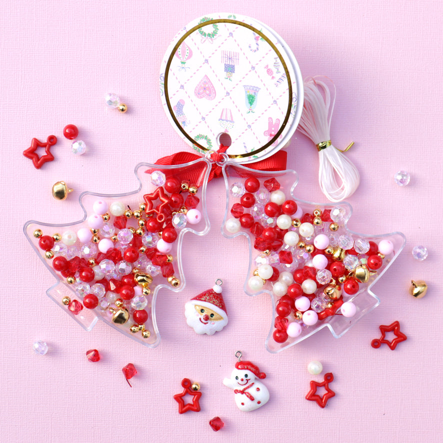 Christmas-themed beaded ornaments on a pink background