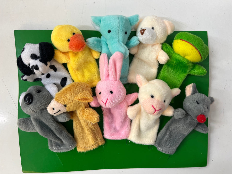 Set of colorful animal  finger puppets  toys on a green background