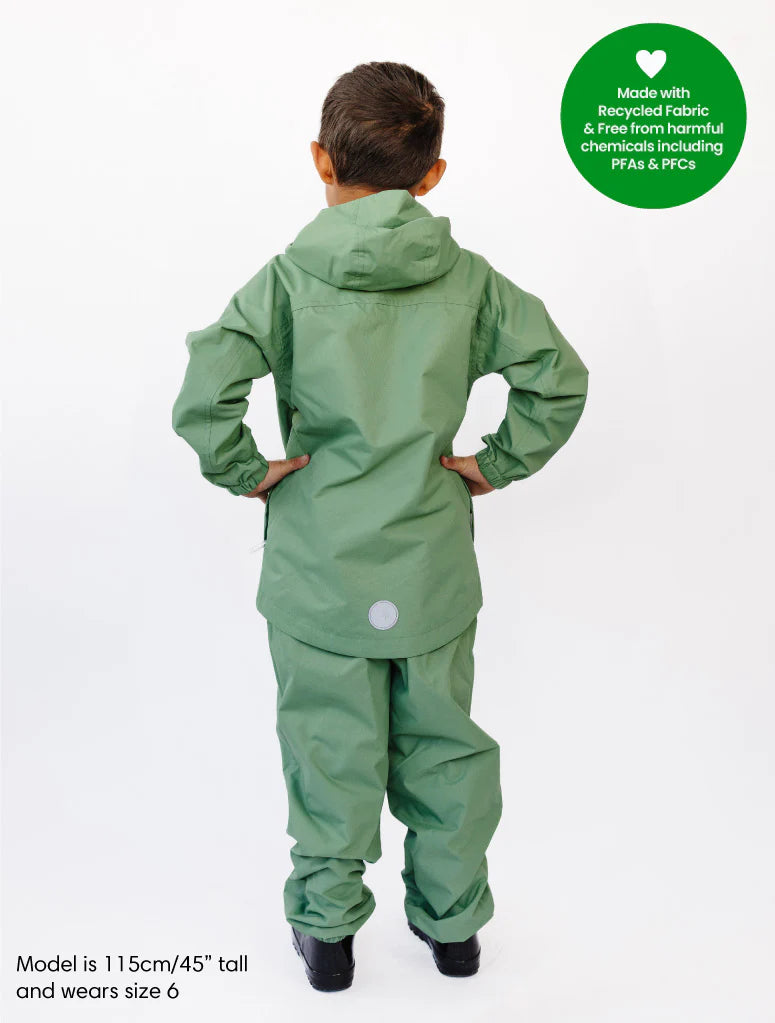 Child wearing a green raincoat and pants with a visible brand label on a white background