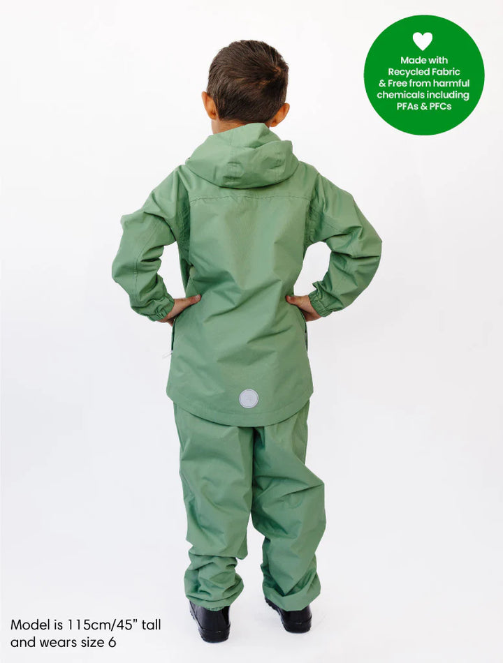 Child wearing a green raincoat and pants with a visible brand label on a white background