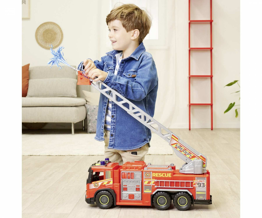 Child playing with a toy dickie giant fire truck in a living room