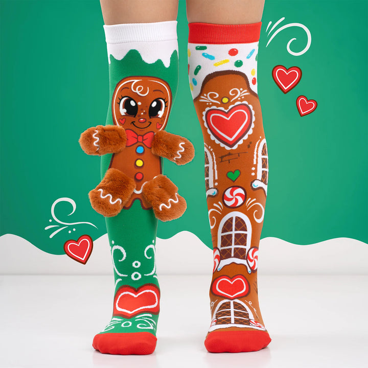 green and brown gingerbread socks being worn by a child on a green and white background