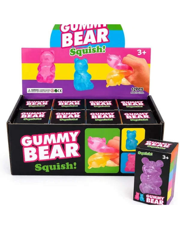 A retail display box and individual package of Gummy Bear Squish! gummy candies. The display box contains multiple small individual boxes of the gummies, with a colorful front panel showing pink, blue, yellow, and purple gummy bears.