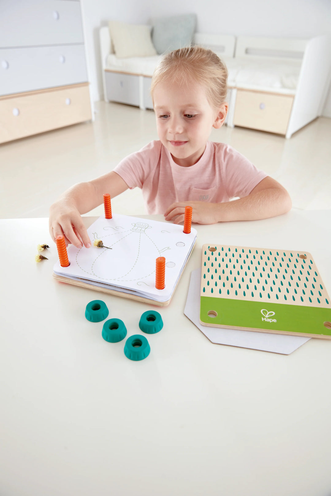Child playing with educational toys on a white surface kidzstuffonline
