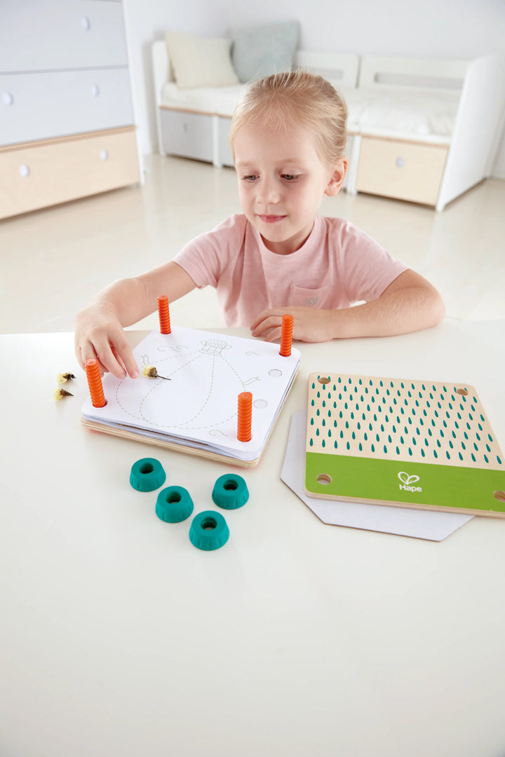Child playing with educational toys on a white surface kidzstuffonline
