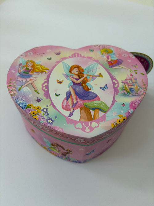 A heart-shaped pink jewellery box decorated with colorful fairy illustrations and floral patterns, photographed on a plain white background.