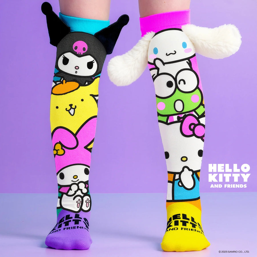 Colorful knee-high socks with cartoon characters on a purple background, featuring 'Hello Kitty and Friends' branding.
