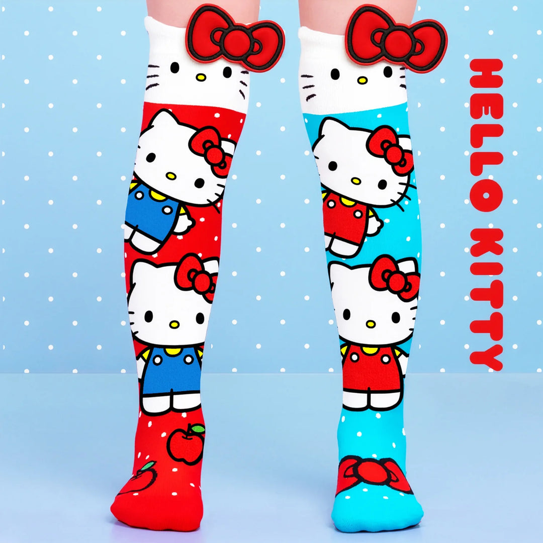 Hello Kitty knee-high socks with red and blue patterns on a light blue background