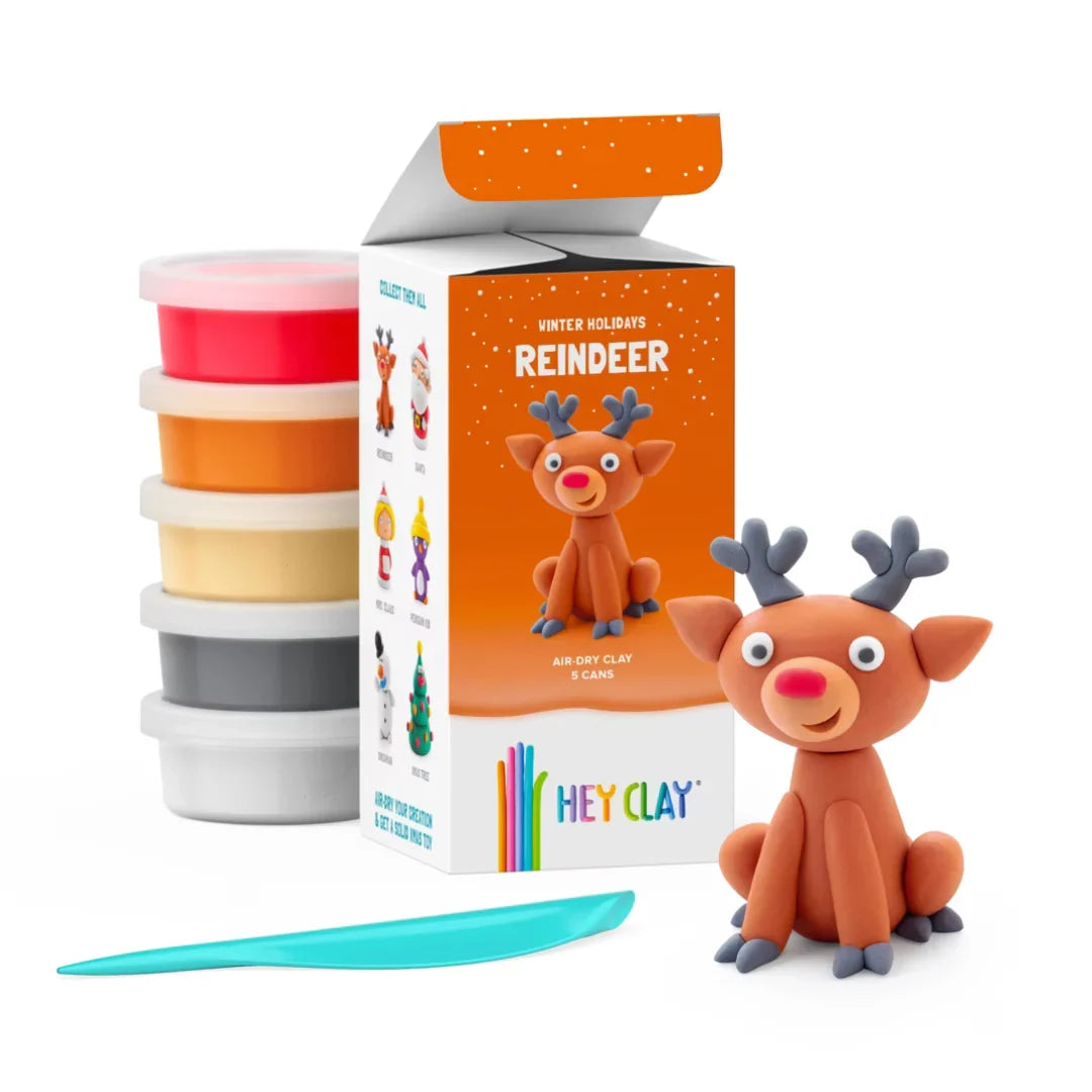 hey clay reindeer sitting next to hey clay packaging and clay as well as modelling tool on a white background