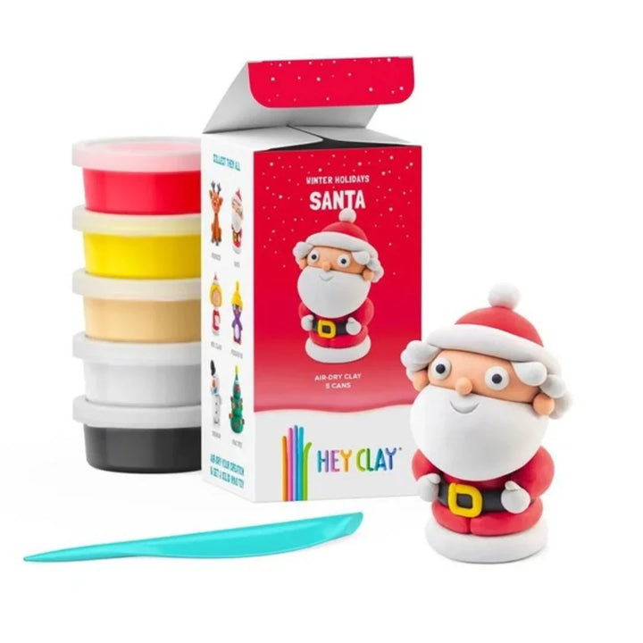 santa made from hey clay next to hey clay red packaging and clay and modelling tool on a white background
