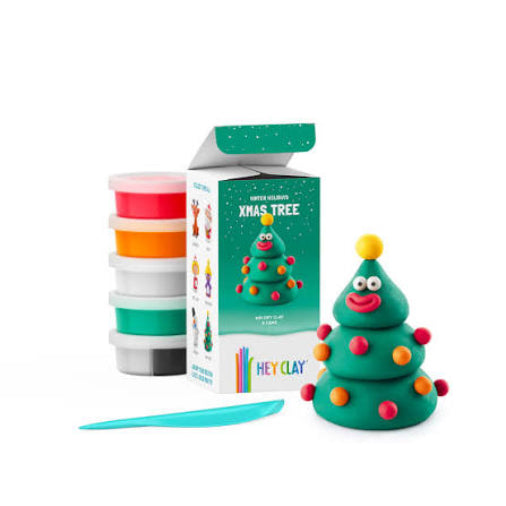 hey clay xmas tree next to green packaging and hey clay pottles and modelling tool on a white background