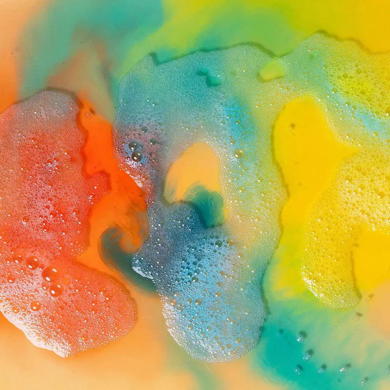 Colorful foam texture with orange, yellow, and blue hues. bath with honeysticks bath colours