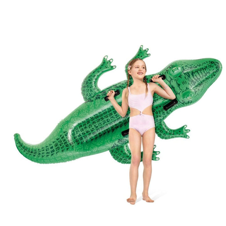 intex crocodile float being held by child on a white background