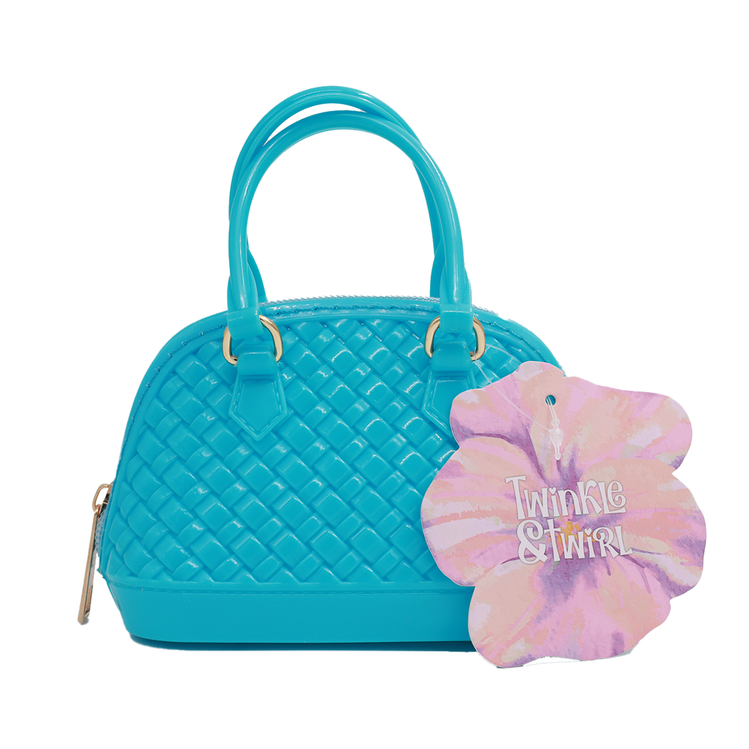 kids Turquoise handbag with a pink and purple hair tie on a white background
