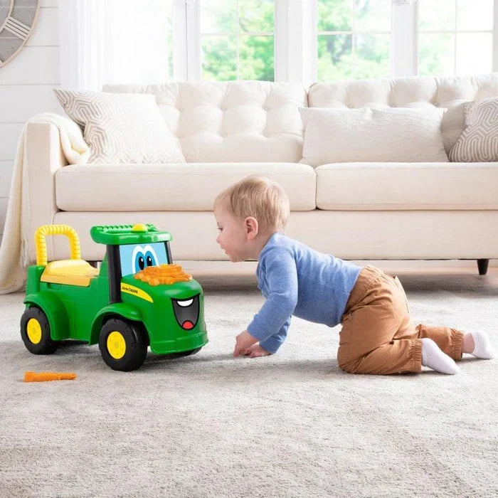 Child playing with a toy tractor in a living room