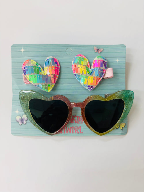 Heart-shaped sunglasses and hair clips on a blue card with butterfly designs.
