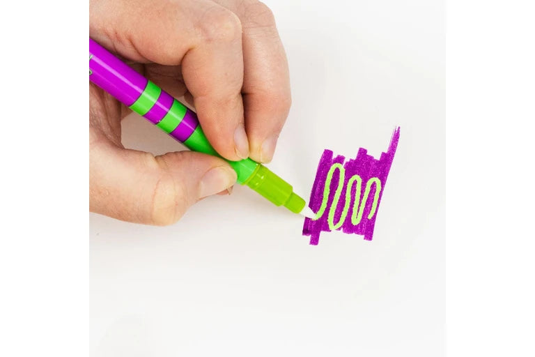 Hand holding a tiger tribe colour change  marker green and purple marker writing on a white background