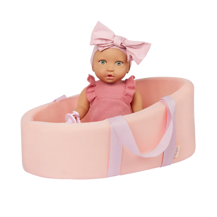 LullaBaby Doll and Carrier Bassinet Baby doll in a pink bassinet with a matching bow headband on a white background