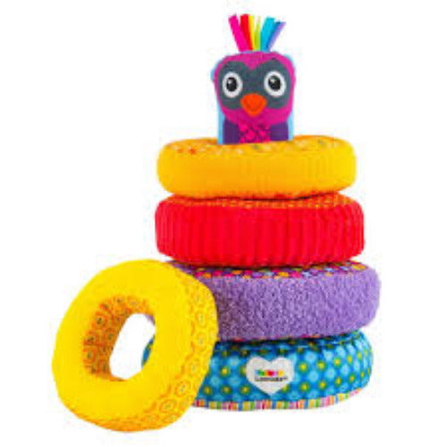 Stack of colorful rings with a small owl toy on top against a white background