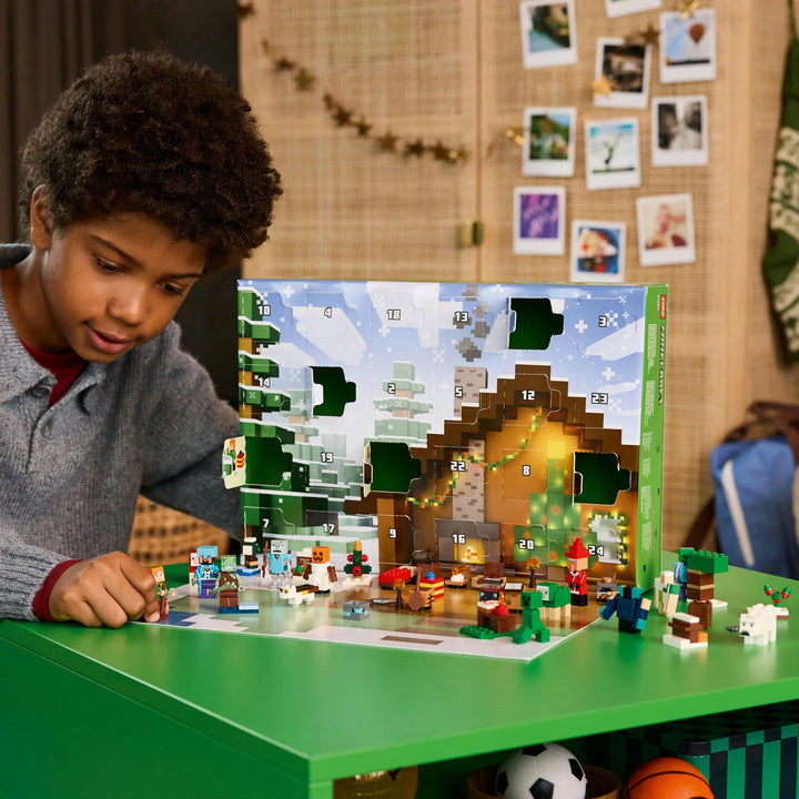 Child playing with a Minecraft-themed lego building set on a green table.