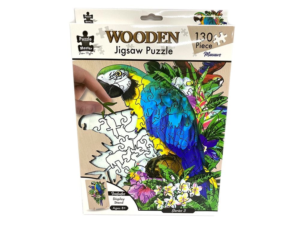 A packaged wooden jigsaw puzzle featuring a colorful parrot and tropical floral design. The box shows 'WOODEN Jigsaw Puzzle 130 Piece' and includes a hand holding a partially assembled section of the puzzle.
