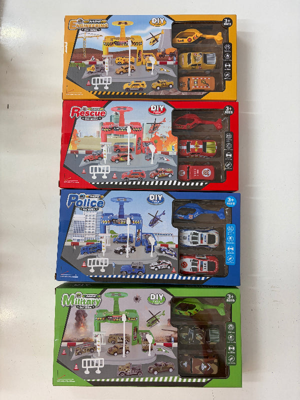 Four boxed DIY toy playsets stacked vertically on a white surface. The packages are for different themed sets: yellow Rescue Station, red Police Station, blue Fire Station, and green Muttay Station, each showing the assembled toy set through a clear window.