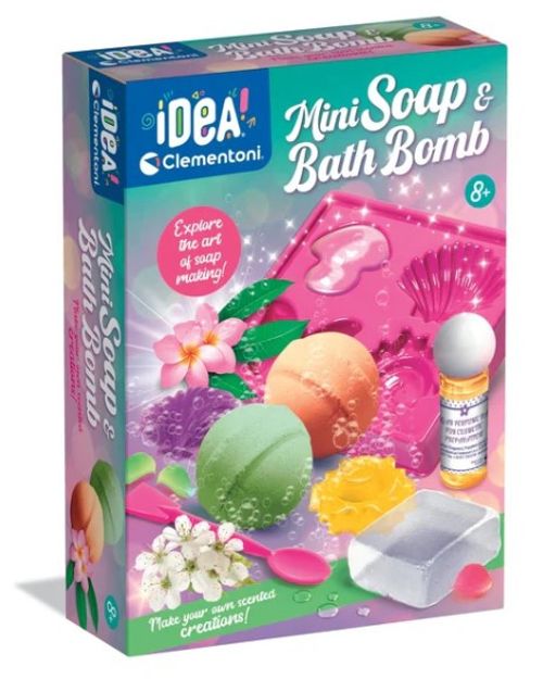 Clementoni iDEA Mini Soap & Bath Bomb craft kit box, featuring colorful illustrations of bath bombs, a soap dish, and an oil bottle on a pink and teal background.