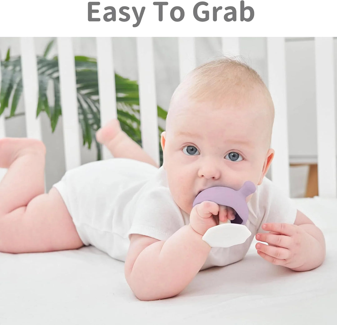 Baby lying in a crib with Mombella Mushroom Soothing Teether Lavender Fog