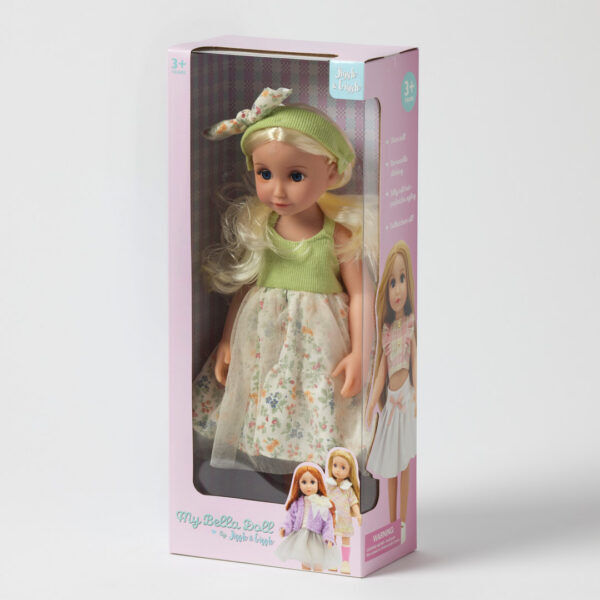 stella doll wearing skirt and green top inside pink packaging