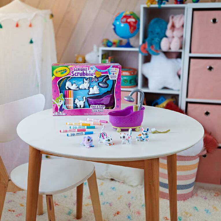 Crayola Scribble Scrubbies set on a children's table with toys in the background
