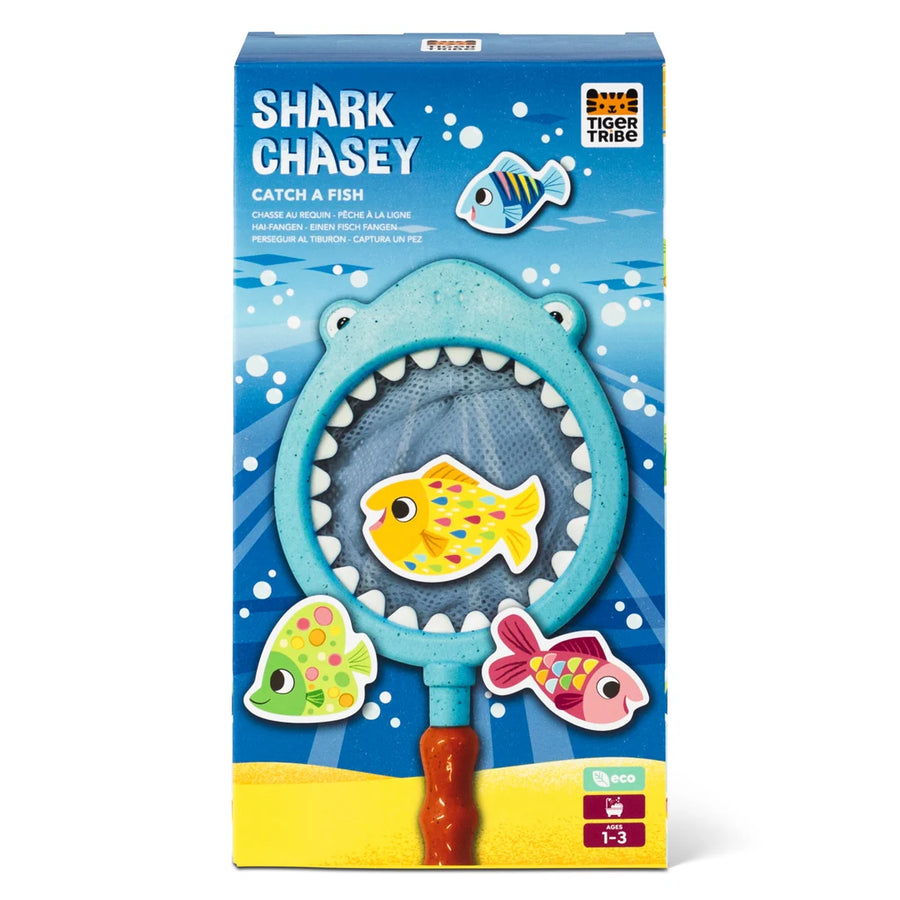 Shark Chasey toy packaging with shark-shaped net and fish illustrations on a blue background.
