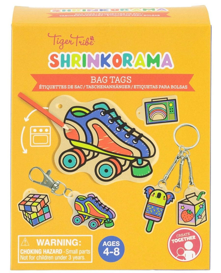 Tiger Tribe Shrinkorama Bag Tags toy set in its original yellow packaging box, featuring colorful illustrations of a roller skate, a Rubik's cube, a popsicle, and a juice box.