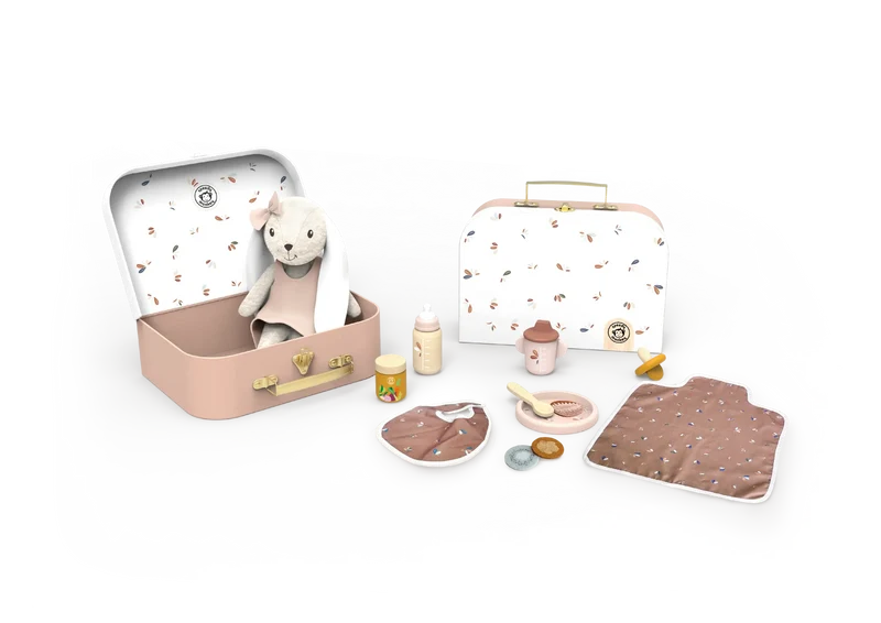 A baby travel set displayed on a white background, featuring two pastel pink metal cases, one open with a plush sheep toy inside and one closed. The set also includes matching accessories such as a bottle, jar, pacifier clip, bib, blanket, and small toy containers, all in soft pink, beige, and brown tones with delicate animal prints.