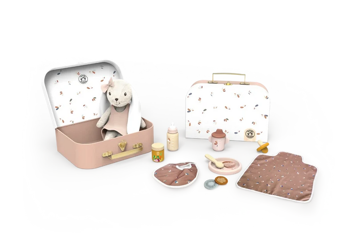 A baby travel set displayed on a white background, featuring two pastel pink metal cases, one open with a plush sheep toy inside and one closed. The set also includes matching accessories such as a bottle, jar, pacifier clip, bib, blanket, and small toy containers, all in soft pink, beige, and brown tones with delicate animal prints.