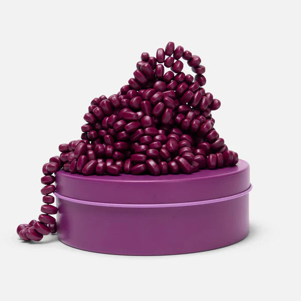 Purple speks magnetic putty with a chain on a white background