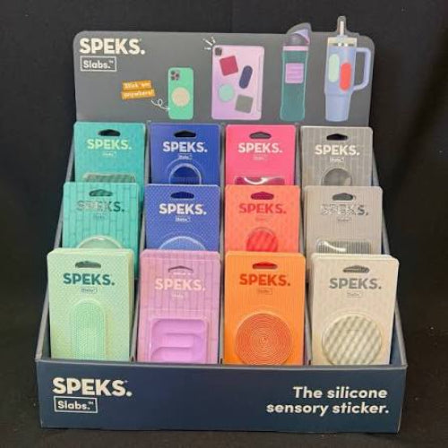 Display of Speks silicone sensory stickers spek slabs with various colors and designs.