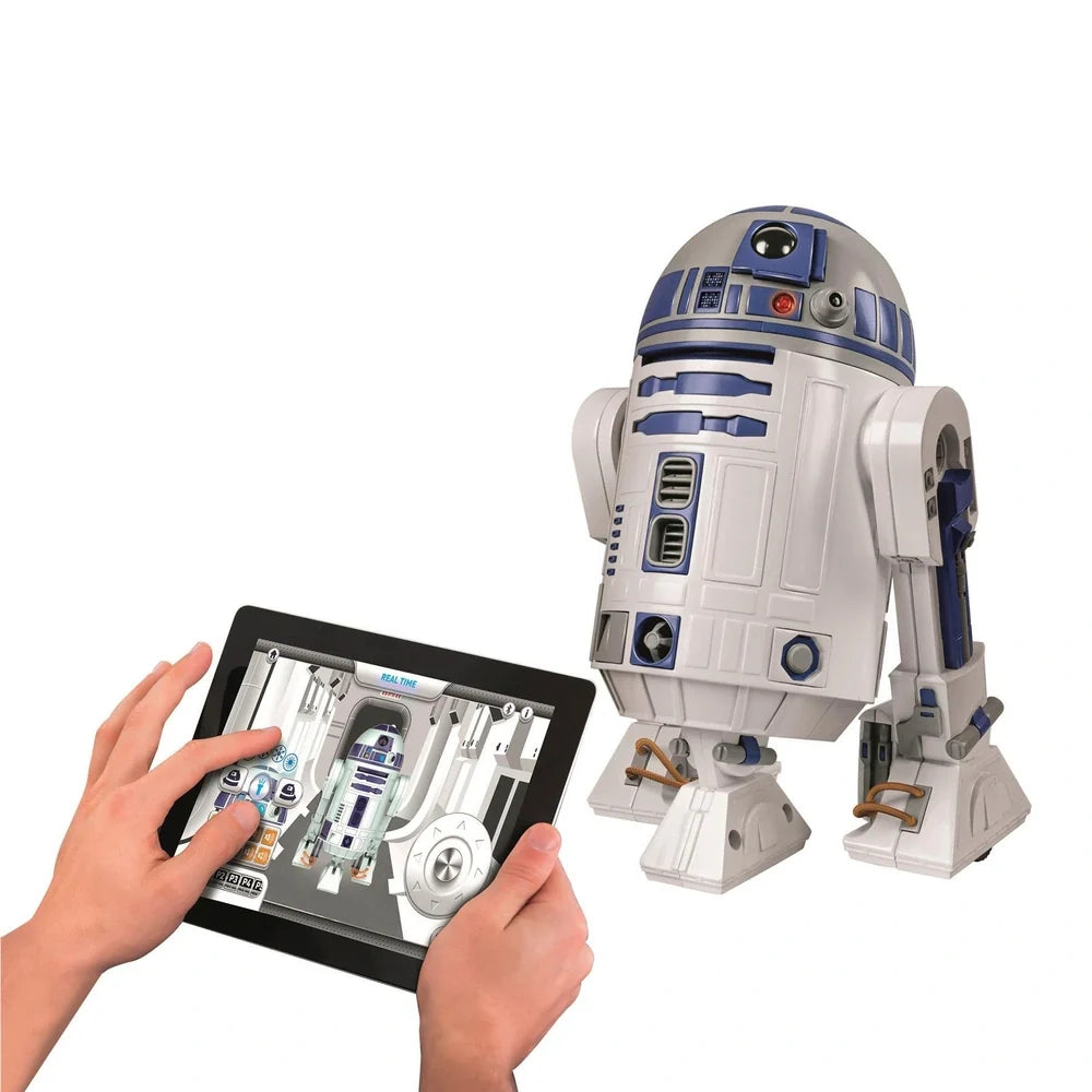 Toy robot R2-D2 from Star Wars interacting with a tablet displaying app interface.