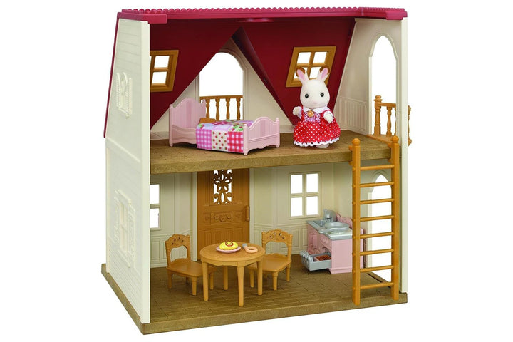 Toy dollhouse with furniture and a rabbit figure on a white background