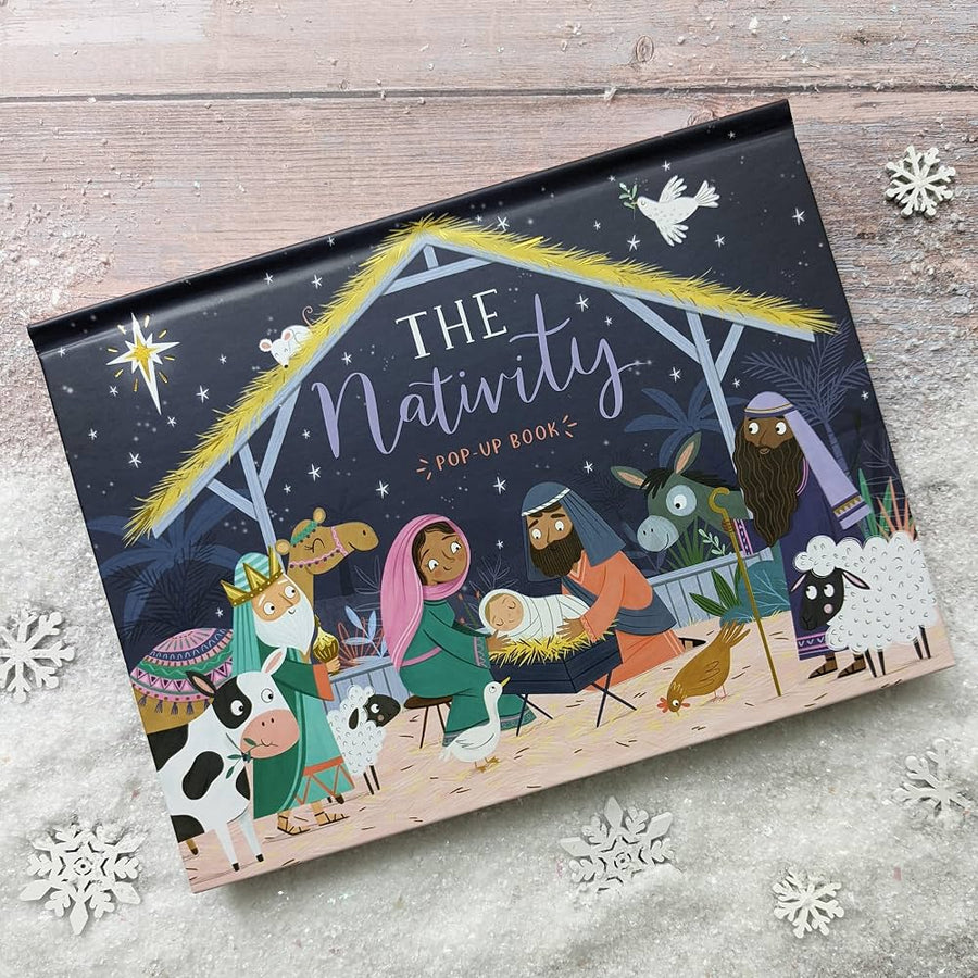 the nativity pop up book on a snowy background