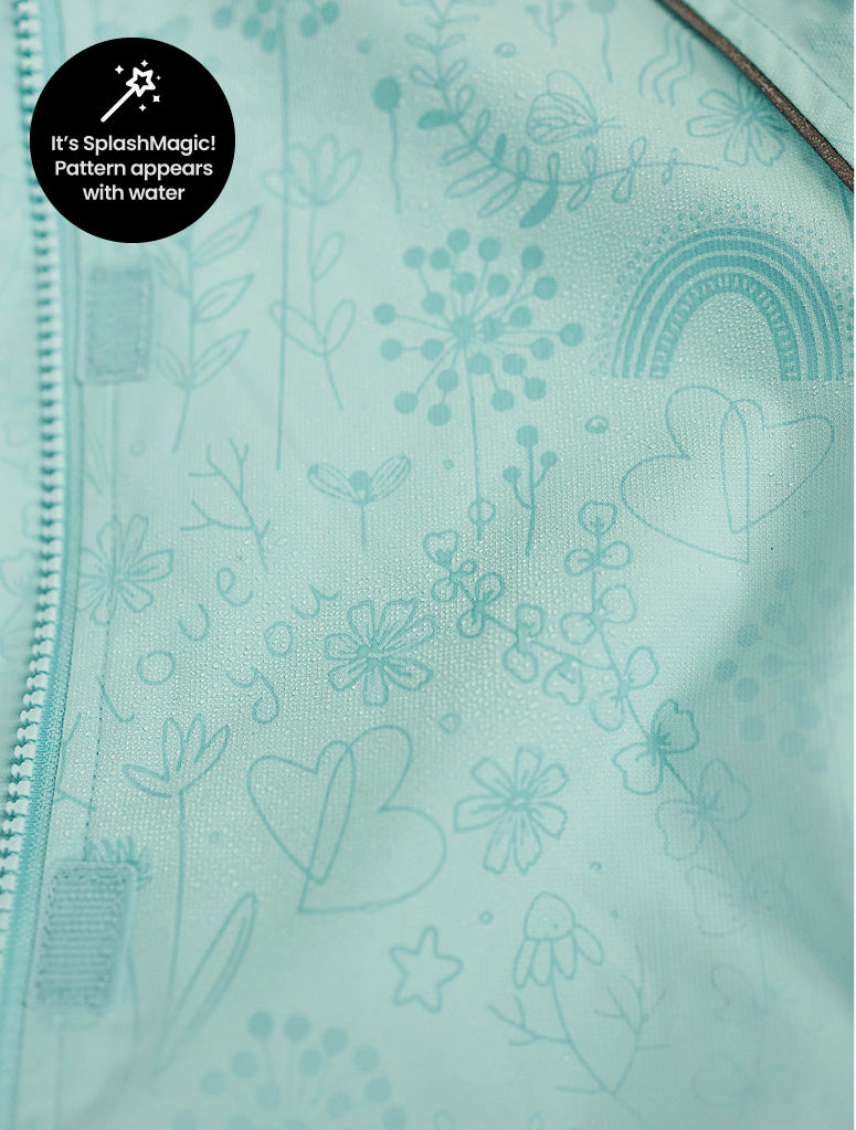 Light blue fabric with floral and heart patterns, featuring a label indicating 'It's Splash Magic! Pattern appears with water'.