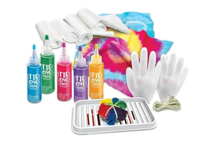 Tie-dye kit with bottles, gloves, and a towel on a white background
