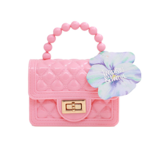 Pink quilted handbag with beaded handle and flower accessory on a white background