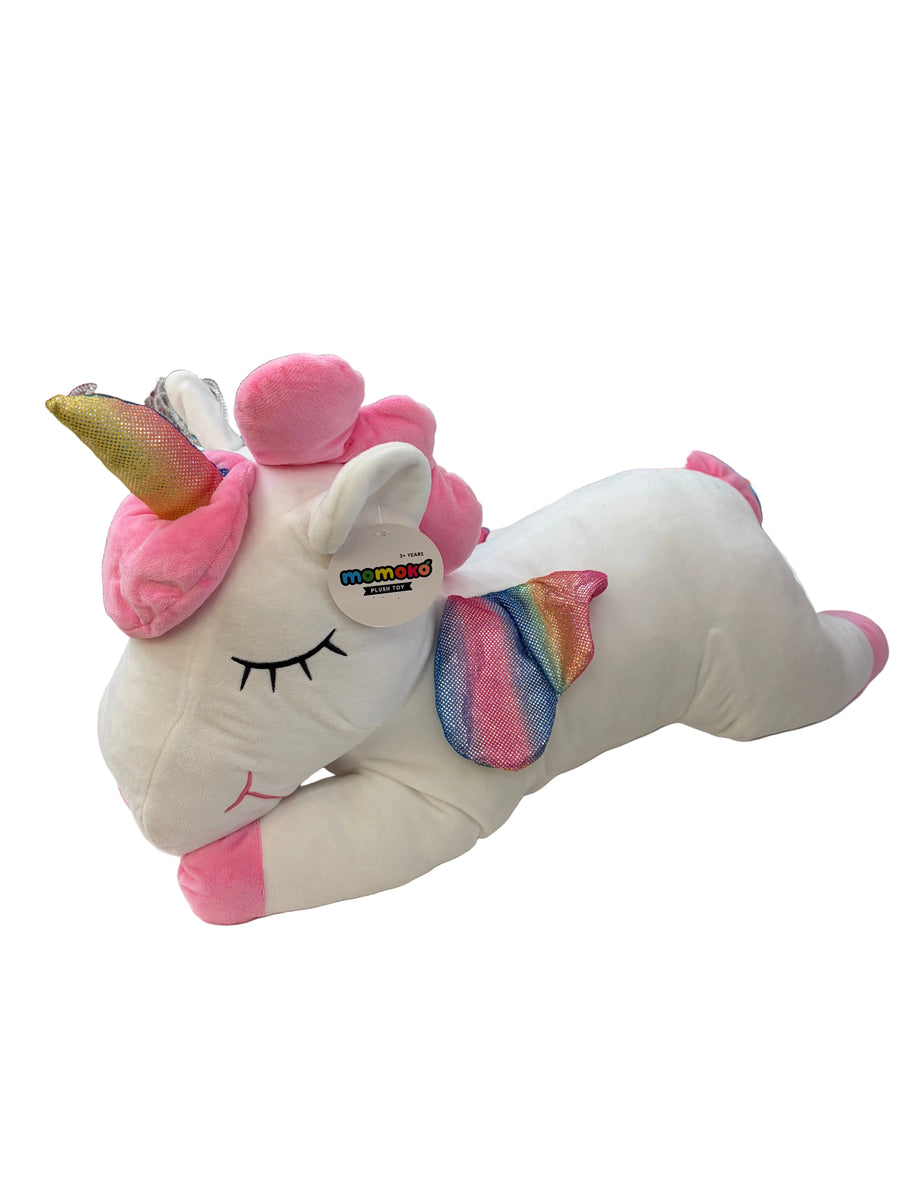 Plush unicorn toy with rainbow tail on a store shelf