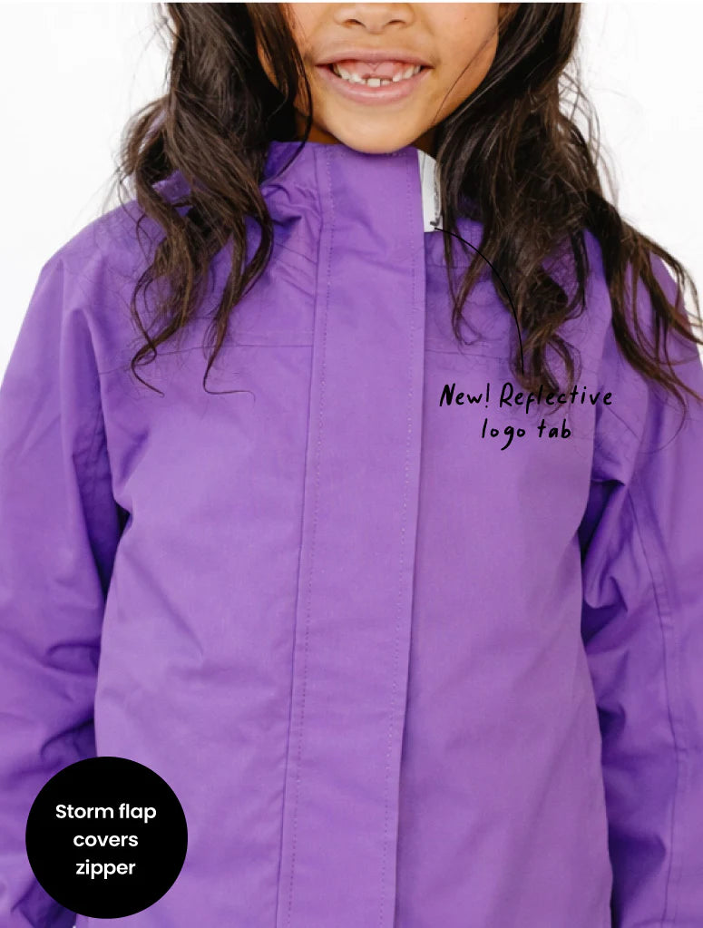 Purple jacket with reflective logo tab feature on a white background