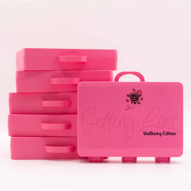 Getting Lost - Well-Being Edition game and Wrapped Suitcase