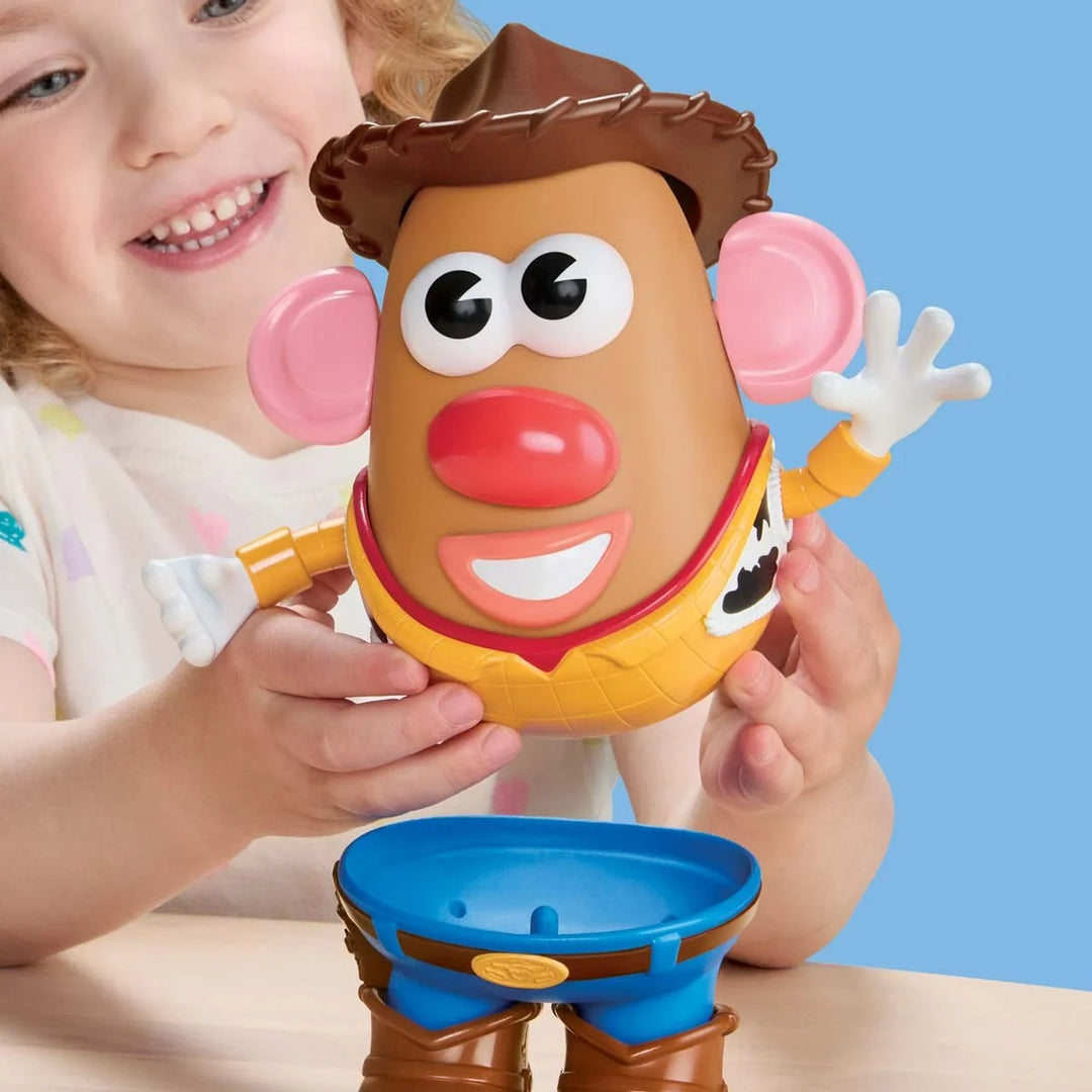Child holding a toy figure with a blue background